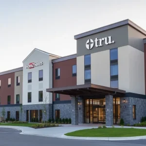 Exterior view of the new dual-brand hotel in Cleveland, Tennessee with Home2 Suites and Tru by Hilton signage.