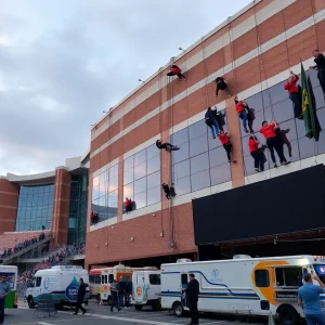 Participants rappelling down a stadium for a fundraising event.