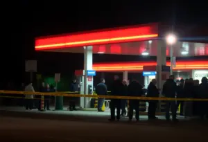 Police vehicles at a gas station after a serious shooting incident